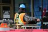 Construction worker on a UK building site wearing a hard hat and high visibility jacket